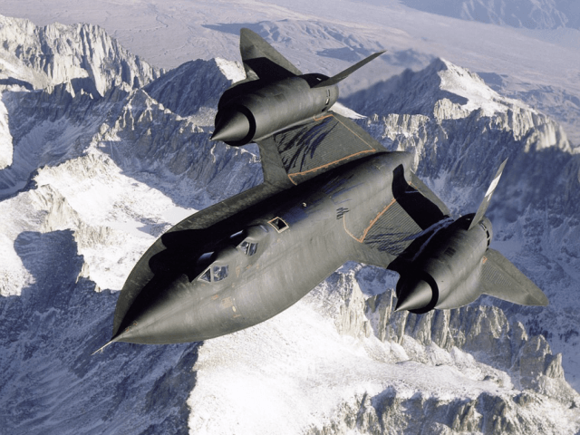 SR-71B Blackbird aerial reconnaissance aircraft photographed over snow capped mountains in