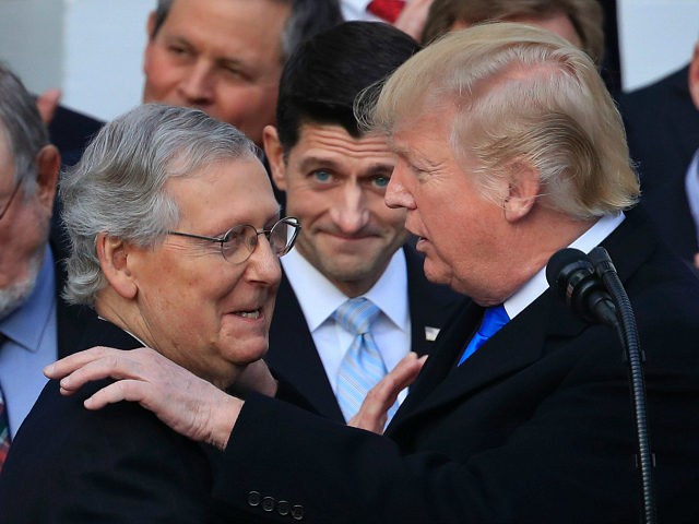FILE - In this Dec. 20, 2017 file photo, President Donald Trump congratulates Senate Majority Leader Mitch McConnell of Ky., while House Speaker Paul Ryan of Wis., looks on during a ceremony at the White House after the final passage of tax overhaul legislation. President Trump plans to open the …