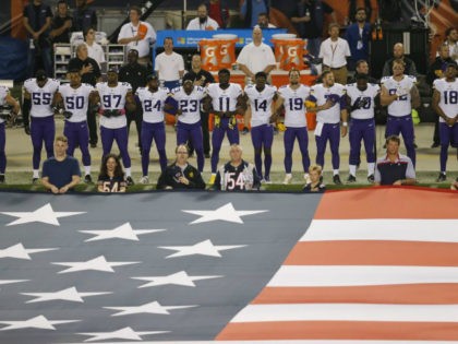 Minnesota Vikings players lock arms during the national anthem before an NFL football game against the Chicago Bears, Monday, Oct. 9, 2017, in Chicago. (AP Photo/Kiichiro Sato)