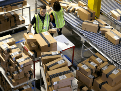 In this Dec. 2, 2013 file photo, Amazon.com employees organize outbound packages at an Amazon.com Fulfillment Center on "Cyber Monday" the busiest online shopping day of the holiday season, in Phoenix. Buying things online could soon get pricier for many people after the U.S. Supreme Court's decision Monday, Dec. 12, …