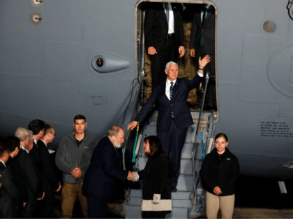 US Vice President Mike Pence waves as he steps off a US Air Force C-17 plane upon arrival