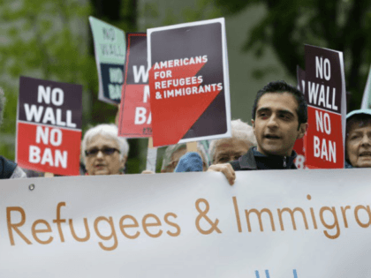FILE--In this May 15, 2017, file photo, protesters hold signs during a demonstration against President Donald Trump's revised travel ban, Monday, May 15, 2017, outside a federal courthouse in Seattle. Trump’s six-month worldwide ban on refugees entering the United States is ending as his administration prepares to unveil new screening …