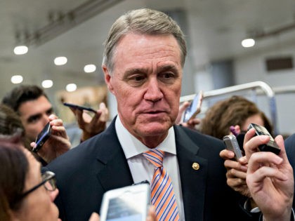 Senator David Perdue, a Republican from Georgia, speaks to members of the media in the basement of the U.S. Capitol after a weekly GOP luncheon meeting in Washington, D.C., U.S., on Tuesday, Nov. 28, 2017. The Senate Budget Committee sent Republicans massive tax-cut bill to the full Senate for a …