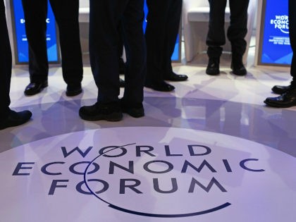 FILE: A WEF logo sits on the stage as panelists talk ahead of a panel session at the World Economic Forum (WEF) in Davos, Switzerland, on Friday, Jan. 22, 2016. President Donald Trump will dominate the Davos forum as no U.S. leader has before: a provocateur-in-chief practiced at tweaking the …