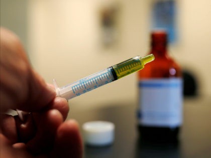 In this Monday, Nov. 6, 2017, photo, a syringe loaded with a dose of CBD oil is shown in a research laboratory at Colorado State University in Fort Collins, Colo. People anxious to relieve suffering in their pets are increasingly turning to oils and powders that contain CBDs, a non-psychoactive …