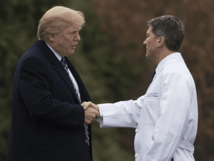 US President Donald Trump shakes hands with White House Physician Rear Admiral Dr. Ronny Jackson, following his annual physical at Walter Reed National Military Medical Center in Bethesda, Maryland, January 12, 2018. / AFP PHOTO / SAUL LOEB (Photo credit should read SAUL LOEB/AFP/Getty Images)