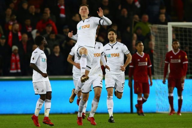 Battling Swansea shock Liverpool