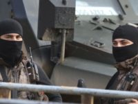Syria Turkish special forces police officers secure a convoy of journalists as Turkey backed opposition fighters of the Free Syrian Army man a checkpoint at the village of Maarin, in the outskirts of the northwestern city of Azaz, Syria, Saturday, Jan. 27, 2018. Fighting raged in northwestern Syria Saturday as Turkish troops and allied militiamen tried to advance their offensive in the nearby Kurdish controlled enclave of Afrin, Syrian opposition activists said. (AP Photo/Lefteris Pitarakis) Turkey advances offensive into Syrian Kurdish enclave