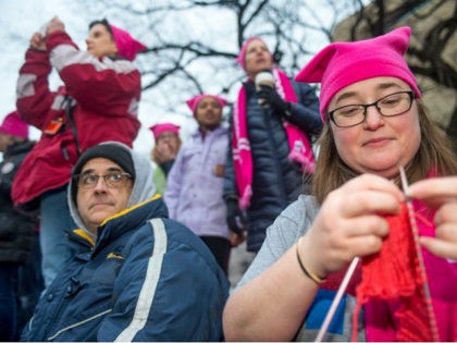 WASHINGTON, DISTRICT OF COLUMBIA - JANUARY 21: Emily Crowley from Vermont knits a pink hat for protesters at the Women's March on Washington on January 21, 2017 in Washington, DC. (Photo by Ann Hermes/The Christian Science Monitor via Getty Images)
