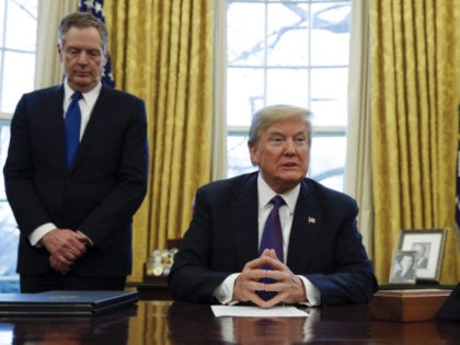 President Donald Trump, joined by U.S. Trade Representative Robert Lighthizer, left, waits for members of the media to take their places before signing Section 201 actions in the Oval Office of the White House in Washington, Tuesday, Jan. 23, 2018. Trump says he is imposing new tariffs to "protect American …