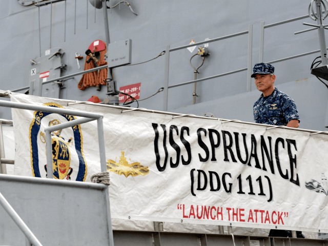 US Navy's Pacific Fleet commander Admiral Harry Harris leaves after visiting the USS Spruance (DDG 111), Arleigh Burke-class guided-missile destroyer (background) which docked in Sembawang wharves in Singapore on January 22, 2014. Admiral Harris, the US Navy's most senior officer in the Pacific region, identified North Korea as its 'number …