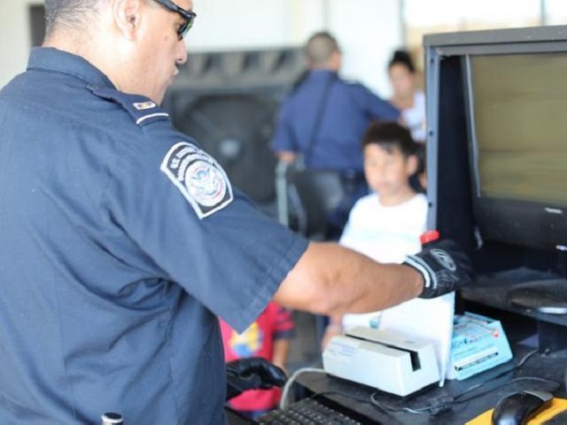 A CBP officer processes arriving bus passengers at Laredo Port of Entry.