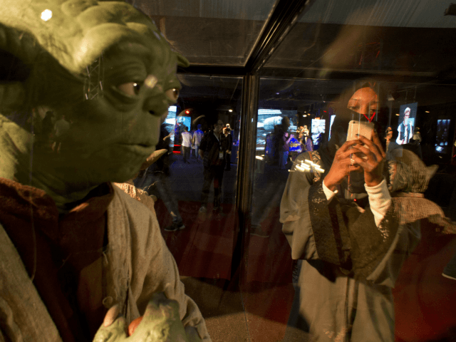 A visitor films at the Star War exhibition, an American epic space opera franchise, center