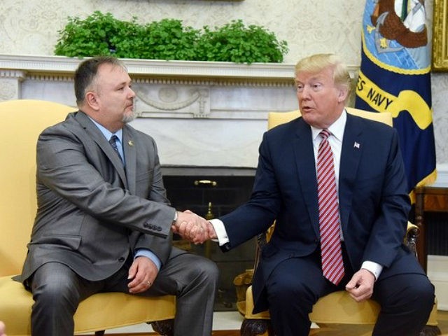 U.S. President Donald Trump, right, shakes hands with Don Bouvet, who has been battling ca