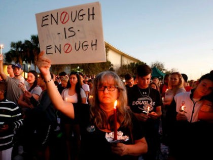 A demonstrator demands action against gun violence during a vigil held for the 17 people killed in the Parkland high school shooting