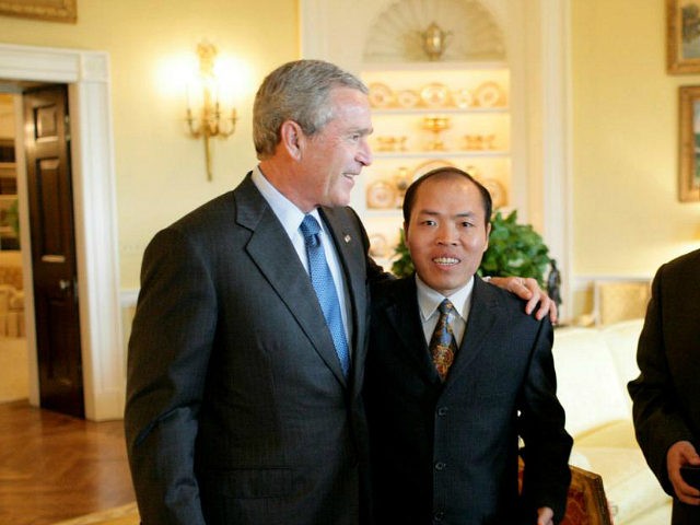 President George W. Bush meets with Chinese Human Rights activists Li Baiguang, Wang Yi, and Yu Jie in the Yellow Oval Room of the White House in Washington, DC on May 11, 2006. (Photo by Eric Draper/WireImage)