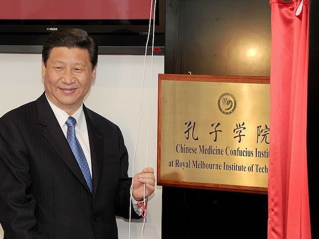 China's Vice President Xi Jinping unveils the plaque at the opening of Australia's first Chinese Medicine Confucius Institute at the RMIT University in Melbourne on June 20, 2010. The Confucius Institute will promote the study of Chinese culture and language with a focus on Chinese Medicine - one of the …