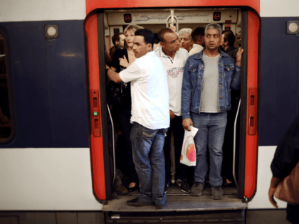 Commuters wait for the departure of a RER regional train at the Denfert-Rochereau station