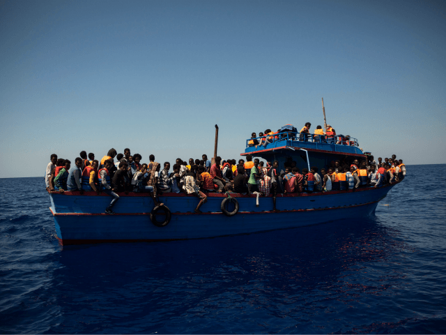 TOPSHOT - Migrants wait to be rescued by the Aquarius rescue ship run by non-governmental