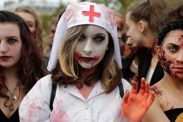 Participants attend the "Zombie Walk" in Paris on October 7, 2017. / AFP PHOTO /
