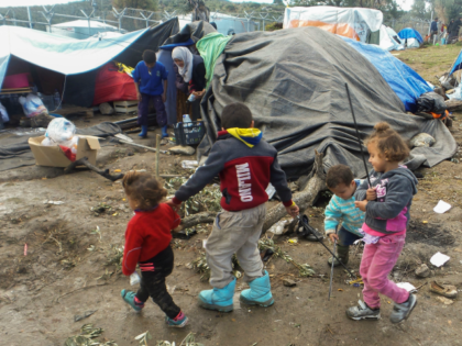 Children play by their families' tents at the overcrowded Moria migrant camp on the i