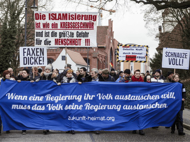 COTTBUS, GERMANY - FEBRUARY 03: Participants holds a front banner with the slogan 'When a government exchanges its people, the people must exchange their government' in an event organized by the right-wing group 'Zukunft Heimat' (Future Homeland), gather to protest against the high number of mostly Muslim refugees who have …
