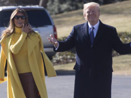 TOPSHOT - US President Donald Trump and First Lady Melania Trump walk to Marine One upon p