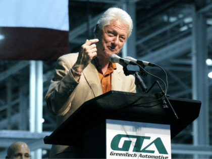 In this July 6, 2012 photograph, former President Bill Clinton speaks during the unveiling of GreenTech Automotive's new electric MyCar at their manufacturing facility in Horn Lake, Miss. (AP Photo/Rogelio V. Solis)