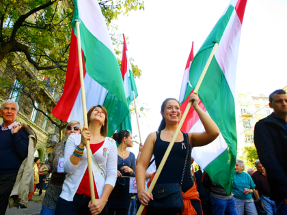 Supporters of the Hungarian government hold the Hungarian flag as they march to commemorat
