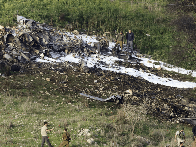 Israeli security stands around the wreckage of an F-16 that crashed in northern Israel, ne