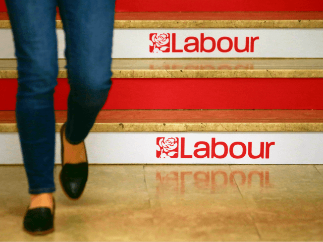 A woman walks down the stairs at a conference centre hosting the Labour party Conference i