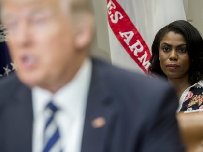 Omarosa Manigault (R), White House Director of Communications for the Office of Public Liaison, sits behind US President Donald Trump as he speaks during a meeting with teachers, school administrators and parents in the Roosevelt Room of the White House in Washington, DC, February 14, 2017. / AFP / SAUL …