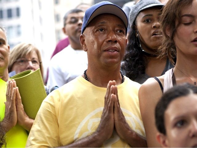Russell Simmons, co-founder of Def Jam records, participates in a session of yoga, led by yoga instructor Seane Corne, in collaboration with the "Occupy Wall Street" protests in Zuccotti Park in New York, on Monday, Oct. 10, 2011. (AP Photo/Andrew Burton)