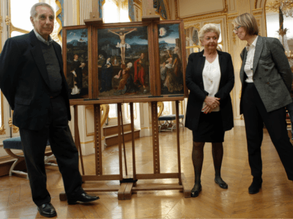 French Culture Minister Francoise Nyssen, right, poses with Henrietta Schubert , second right, and Christopher Bromberg, left, grandchildren of Henry and Hertha Bromberg, next to the oil work entitled 'Triptych of the Crucifixion' attributed to Flemish painter Joachim Patinir during a ceremony of restitution at Culture ministry in Paris, Monday, …