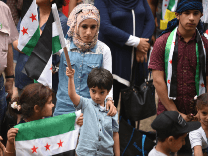 n this photo taken on October 11, 2015 ethnic Syrians attend a rally in support of refugee