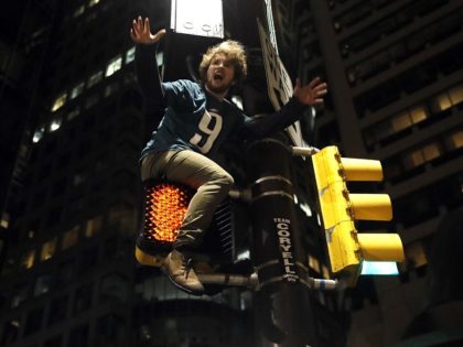 A Philadelphia Eagles fan celebrates the team's victory in the NFL Super Bowl 52 between the Philadelphia Eagles and the New England Patriots, Sunday, Feb. 4, 2018, in downtown Philadelphia. (AP Photo/Matt Rourke)