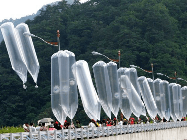 Photo: South Korean conservative activists launch large cylinder-shaped balloons into the