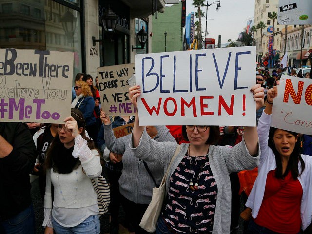 Participants march against sexual assault and harassment at the #MeToo March in the Hollywood section of Los Angeles on Sunday, Nov. 12, 2017. (AP Photo/Damian Dovarganes)