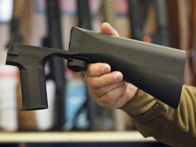 A bump stock device that fits on a semi-automatic rifle to increase the firing speed, making it similar to a fully automatic rifle, is shown here at a gun store on October 5, 2017 in Salt Lake City, Utah. Congress is talking about banning this device after it was reported …