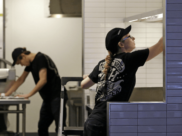 Workers clean inside a still-closed Chipotle restaurant Monday, Nov. 9, 2015, in Seattle. Health officials in Washington and Oregon have said that more than three dozen people have gotten sick with E. coli in an outbreak linked to Chipotle restaurants in the two states. More than 40 Chipotle restaurants remain …