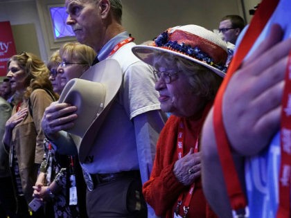 NATIONAL HARBOR, MD - FEBRUARY 22: Attendees listen to the national anthem during CPAC 201
