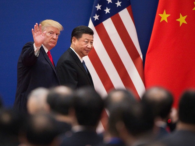 US President Donald Trump (L) and China's President Xi Jinping leave a business leaders ev
