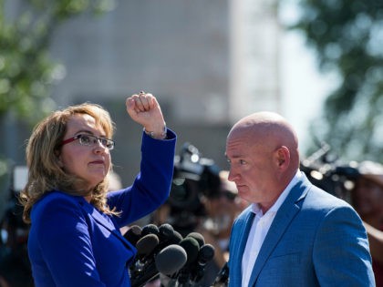 UNITED STATES - OCTOBER 2: Former Congresswoman Gabrielle Giffords, D-Ariz., turns to shake her fist at the Capitol as her husband retired NASA astronaut Captain Mark Kelly looks on during their news conference at the U.S. Capitol on Monday, Oct. 2, 2017, to respond to last nights tragic mass shooting …