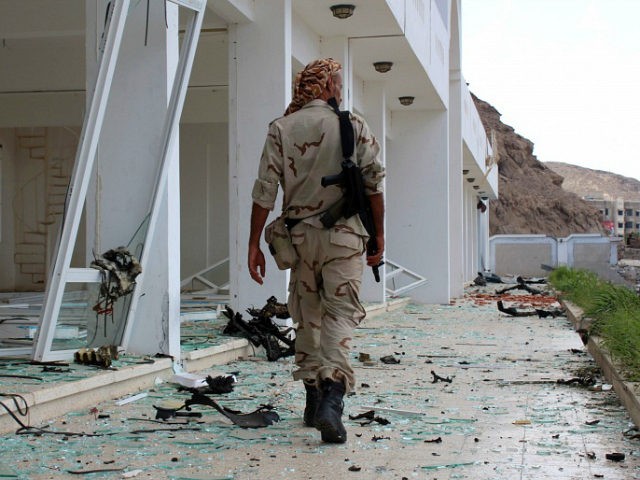A fighter from the separatist Southern Transitional Council gather on February 25, 2018, at the site of two suicide car bombings that targeted the headquarters of an anti-terror unit the day before, in the southern Yemeni port of Aden. Five people, including security officers and a child, died in the …