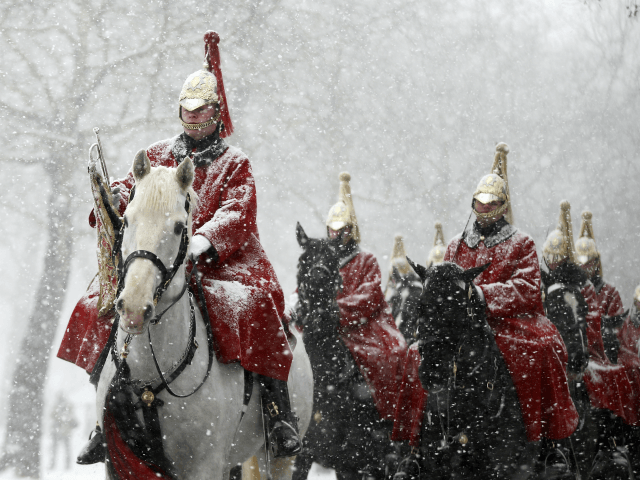 Members of the Household Cavalry return to their barracks as snow falls in London, Wednesday, Feb. 28, 2018. Britain, which is buffered by the Atlantic Ocean and tends to have temperate winters, saw heavy snow in some areas that disrupted road, rail and air travel and forced hundreds of schools …