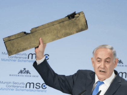 In this photo released by Lennart Preiss/MSC 2018, Israeli Prime Minister Benjamin Netanyahu, holds a part of a downed drone during his speech at the Munich Security Conference, MSC, in Munich , Germany, Sunday, Feb. 18, 2018. (Lennart Preiss/MSC 2018/dpa via AP)