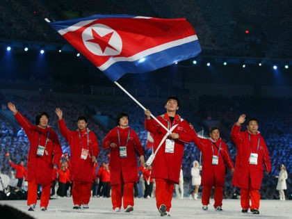 FEBRUARY 12: Song Chol Ri of North Korea carries the national flag during the Opening Cere