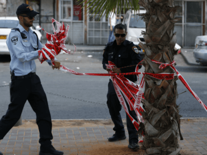 Israeli policemen remove the barrier tape at the scene where police said a Jewish man was stabbed with a screwdriver in the east Jerusalem neighborhood of Al-Tur on August 11, 2016 A Palestinian man stabbed and wounded a young Jewish man in Jerusalem before fleeing, in what Israeli police said …