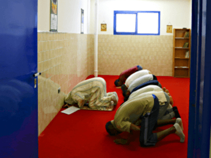 In this photo taken on Friday, June 23, 2017, inmates pray with the Imam Mimoun El Hachmi,