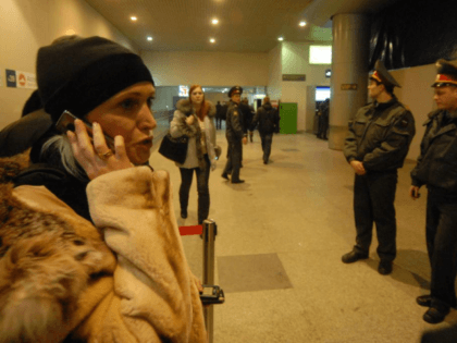 A woman speaks by phone at the Domodedovo airport in Moscow after an explosion on January